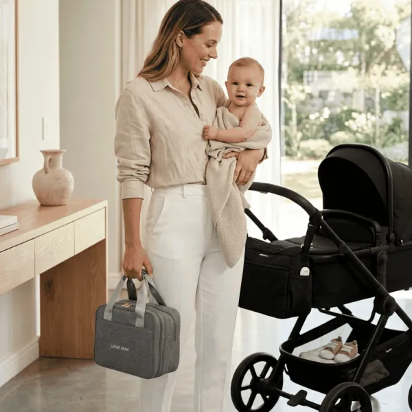 Mum carrying a grey Leche Mum breast pump bag beside a stroller
